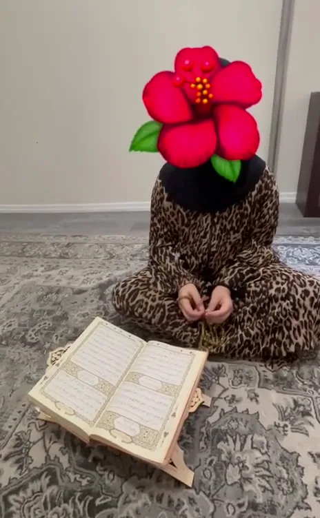OQLS student seated beside an open Quran on a stand