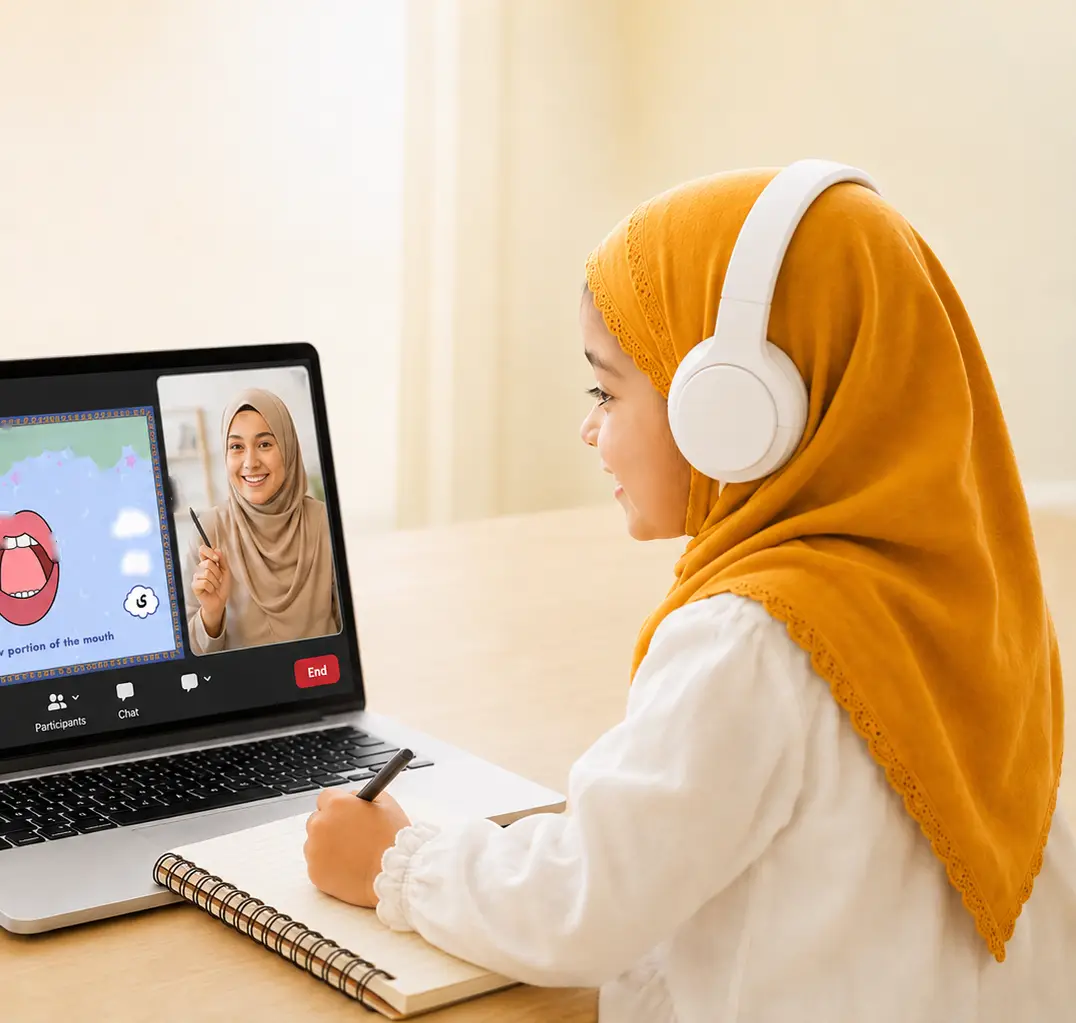 A girl in a headscarf writes in her notebook during a live online Quran lesson with a female teacher on the laptop