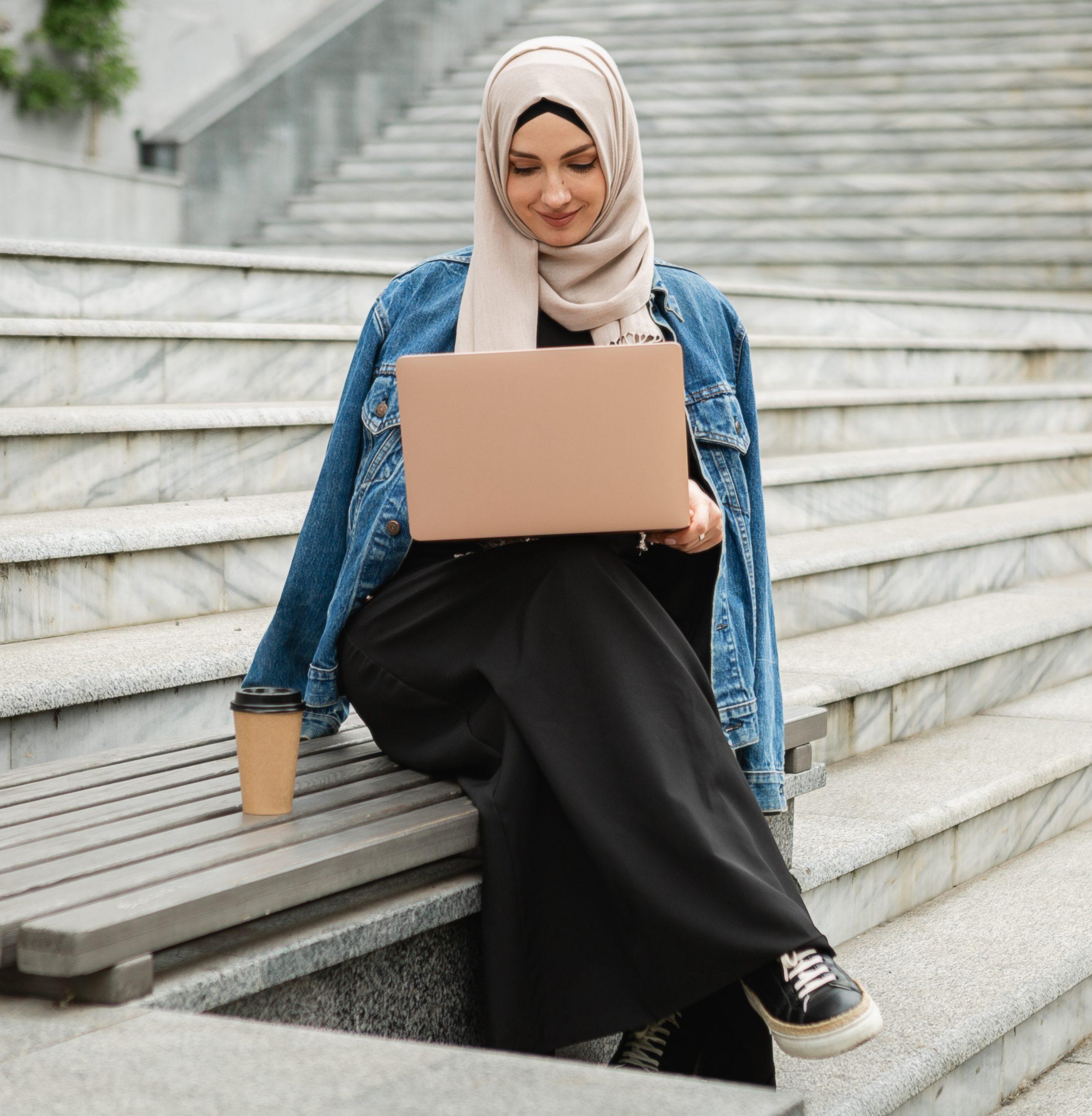 modern stylish muslim woman in hijab in city street